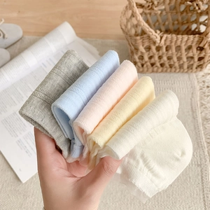 Close-up of five pairs of breathable lace hollow knit socks in soft pastel colors