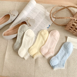 Detail showing five pairs of pastel cotton socks with delicate lace trim and vertical ribbing