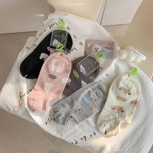 Flat lay of five colors of thin cotton boat socks with cute cartoon dog patterns