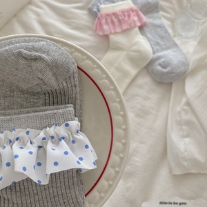 Close-up of polka dot ruffle cuffs and ribbed texture on ballet style cotton socks
