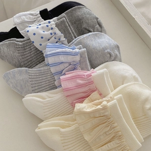Detail of ballet style lace trim socks with polka dots and stripes in assorted colors
