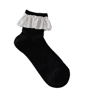 Ballet style black ribbed crew socks with gray striped ruffle trim on white background