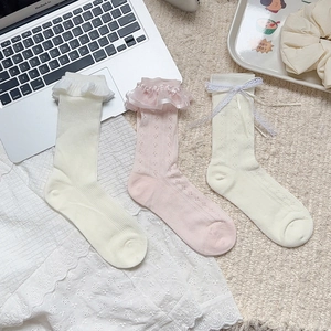 Sweet lace socks for women featuring mesh hollow patterns and satin ribbon bow accents