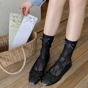 Japanese style white Lolita mid-tube socks with delicate lace mesh and bow details