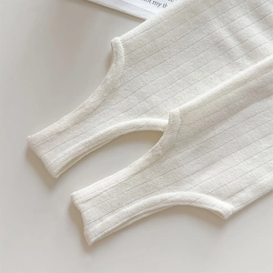 Detailed macro view of white ribbed knit fabric texture and high-quality stitching