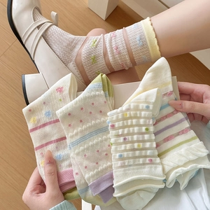 Detail of sweet cotton mesh socks with colorful polka dots, stripes and ruffle trim