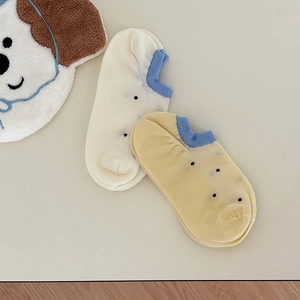 Detailed view of low-cut cotton socks with black polka dots and blue heel accents
