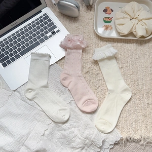 Detailed view of women's lace socks with mesh texture and delicate bow ruffles