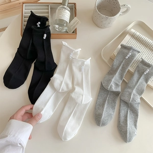 Detail of ballet style ribbed crew socks with pearl accents in black, white, and grey