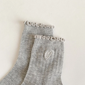 Detail of light gray mesh cotton socks with white heart embroidery and ruffle trim edge
