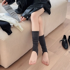 Detailed knit ribbed texture of stirrup leg warmers in multiple neutral colors