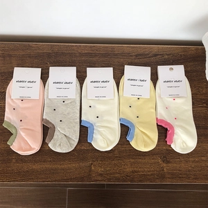 Detailed set of five polka dot cotton low cut socks with colorful contrast heel tabs