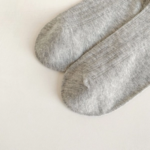 Close-up of the breathable grey marl knit texture and toe seam on the cotton socks