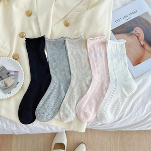 Close-up of five mesh knit socks featuring diamond hollow patterns and elegant wavy edges