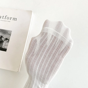 Detail of white thin breathable mesh socks with vertical ribbed texture and ruffles