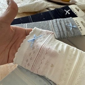 Detailed view of breathable pointelle knit mesh socks with sweet ribbon bow decoration
