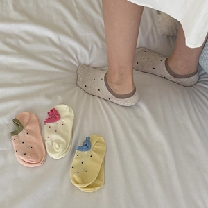 Close-up of low cut cotton boat socks with colorful polka dots and contrast trim