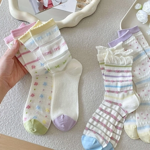 Detail of breathable mesh summer socks with sweet floral patterns and ruffled edges