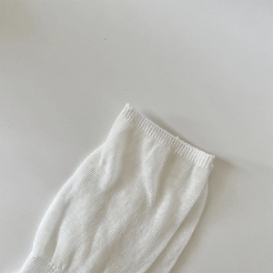 Macro detail of breathable white knit fabric with elastic ribbed cuff for a ballet style
