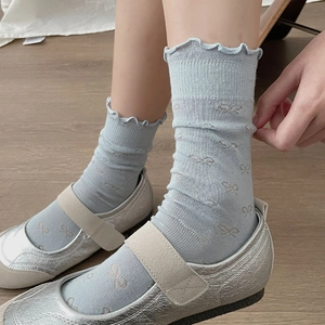 Sweet light blue socks with bow patterns, ruffle cuffs, and hollow mesh knit design