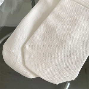 Detail shot of white ribbed cotton socks featuring precise toe stitching and soft texture