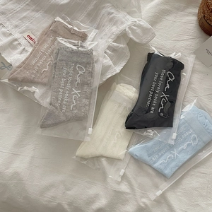 Detailed view of 5-pack hollow-out mesh socks in neutral tones with zipper bags