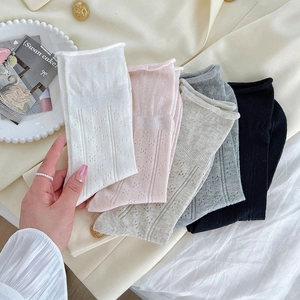 Close-up of mesh pointelle hollow socks in white, pink, grey and black colors