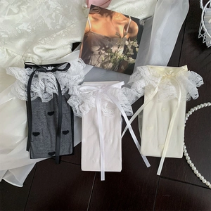 Detailed view of Lolita style socks featuring wide lace edges and ribbon bow accents