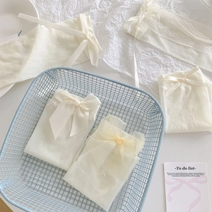 Detailed view of cream white Lolita calf socks with delicate bows and lace edging