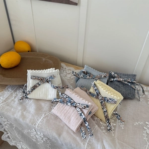 Détail de cinq couleurs de chaussettes en tricot à ruban floral sur une nappe en dentelle