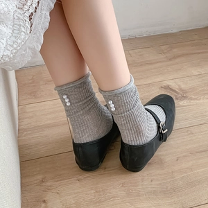 Grey ballet style knit crew socks with pearls and frilled edges worn with Mary Janes