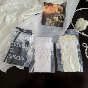Detailed flat lay of black, white, and beige Lolita lace socks in individual packaging