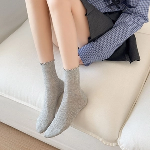 Light gray cotton socks with heart embroidery and ruffle trim shown on person