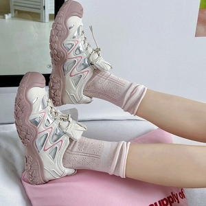 Detail of pink hollow out mesh crew socks paired with cream chunky dad sneakers