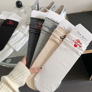 Close-up of cotton mid-calf socks with heart embroidery and Life is a journey slogan