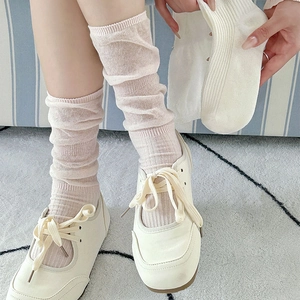 Close-up of ballet-style sheer cream slouch socks paired with matching Mary Jane shoes