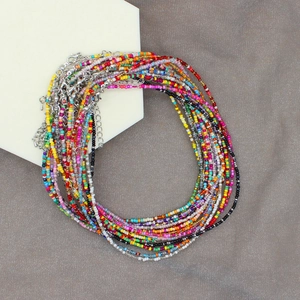 Detailed view of colorful Bohemian seed bead necklaces with silver lobster claw clasps