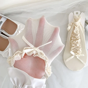 Detailed close-up of breathable off-white lace mesh socks with silk bow decoration