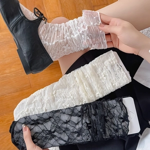 Detail showing white lace floral knee-high socks with delicate hollowed-out crochet patterns