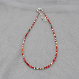 Detail of colorful bohemian seed bead necklace featuring adjustable lobster clasp