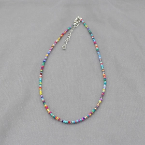 Detail of colorful bohemian seed bead necklace with adjustable silver lobster clasp