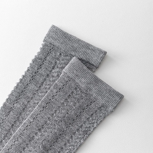 Detailed close-up of grey hollow knit knee-high socks with breathable mesh pattern