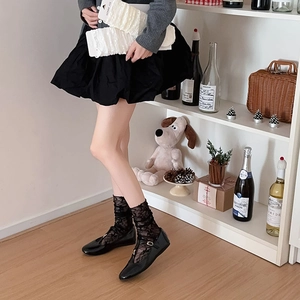 Ballet style white lace flower socks with black Mary Jane shoes in a vintage aesthetic