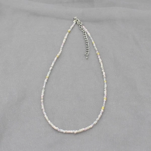 Detail of colorful macaron bead necklace with silver metal adjustable clasp and chain