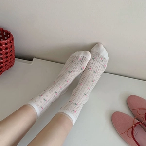 Detail of white mesh crew socks with pink floral embroidery in vintage aesthetic