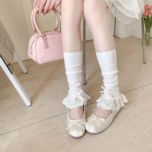 Detailed view of white ribbed Lolita socks with lace ruffles and satin ballet shoes