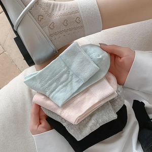 Detail of sweet heart hollow mesh mid-calf socks with breathable knit pattern