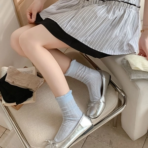Detail of sweet ruffle cuff crew socks with diamond mesh pattern in pastel blue and beige