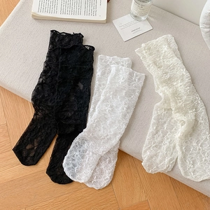 Detailed view of floral lace long socks in black and white with breathable mesh texture