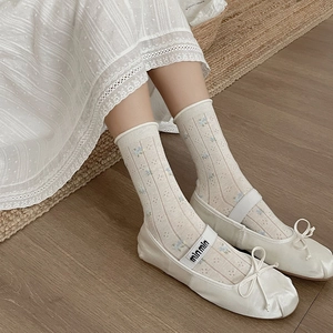 Floral embroidered white crew socks with ballet flats and ribbon bow details